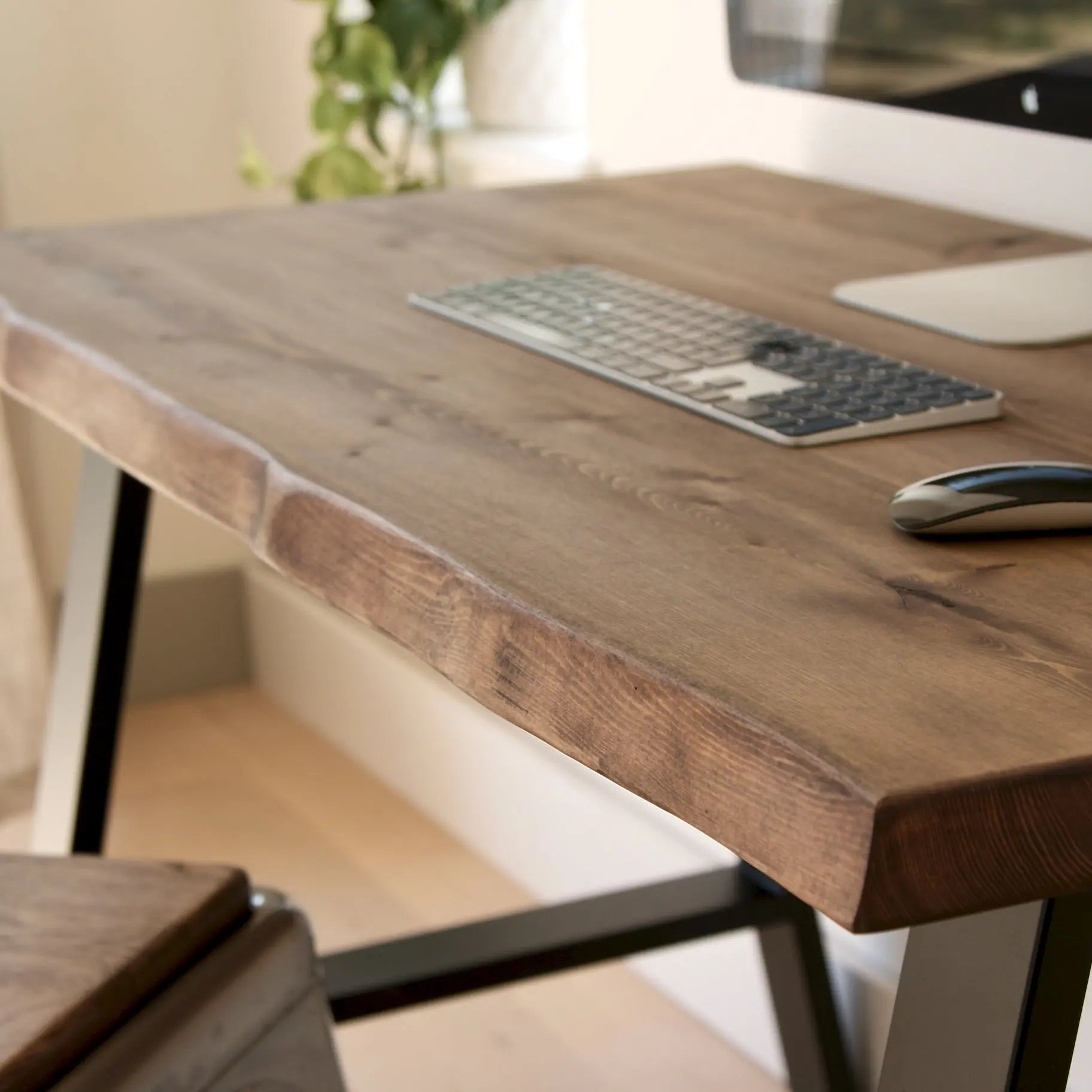 Wooden desk with keyboard and mouse in a home office setting