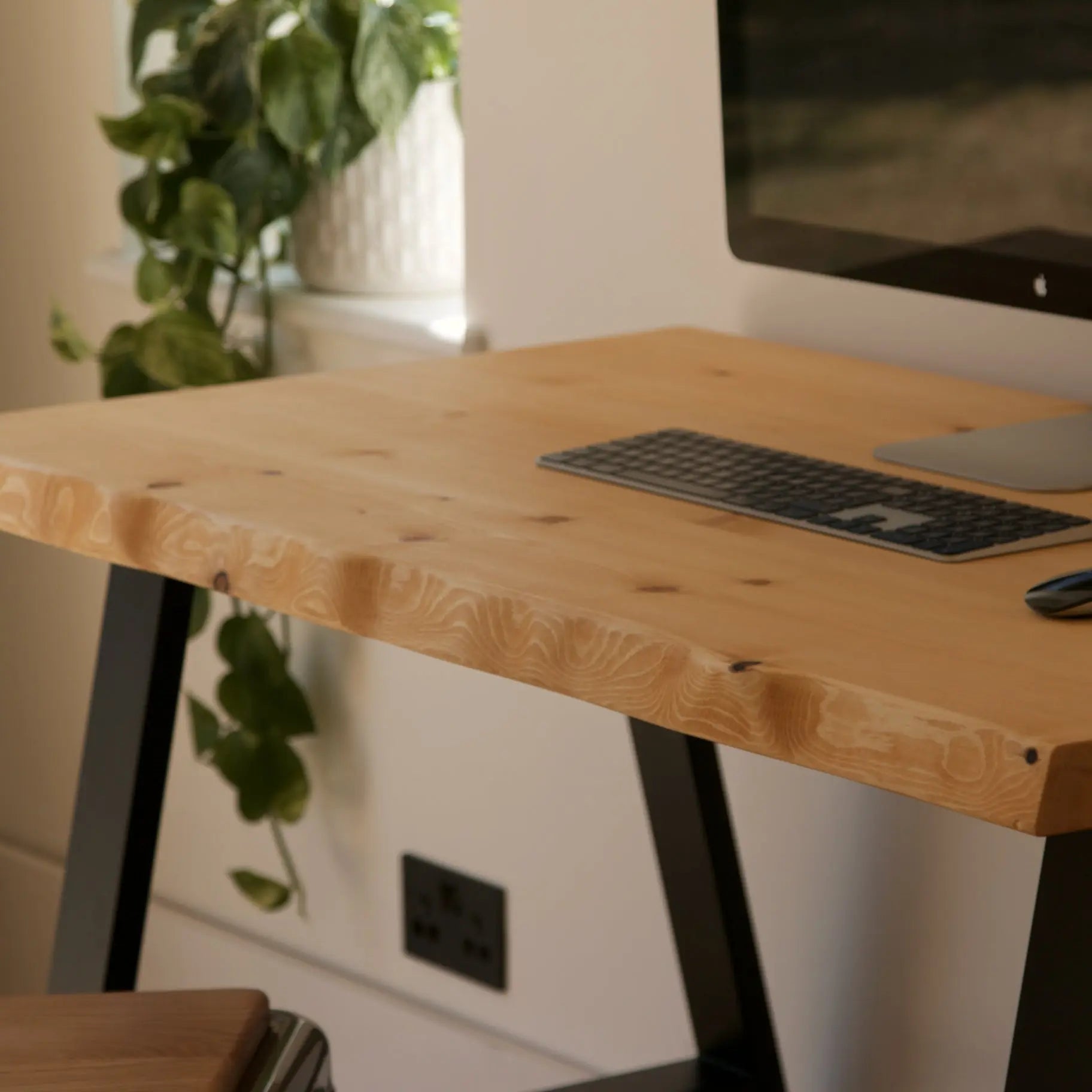 Wooden desk with computer setup in a home office setting