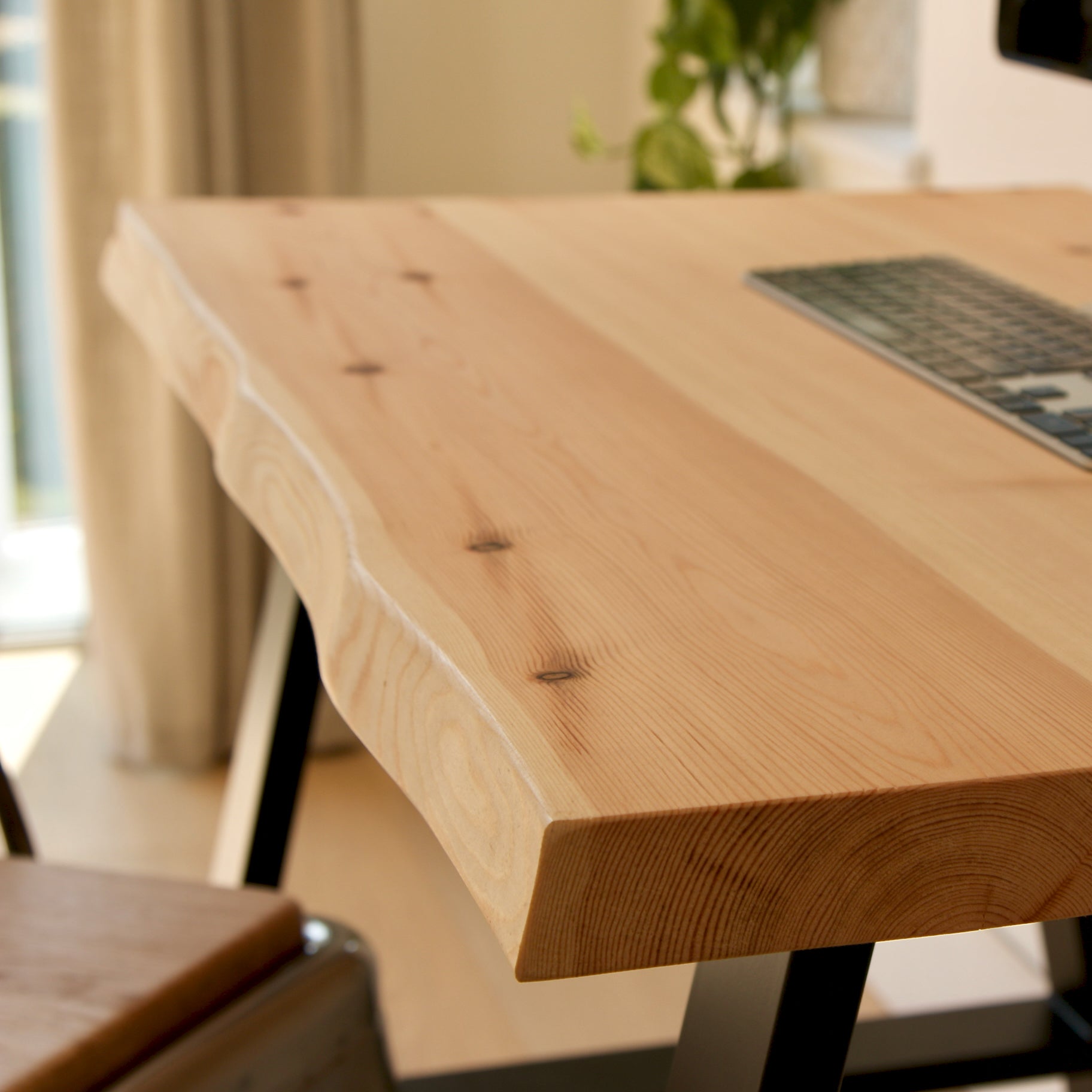 Wooden desk with a laptop in a home office setting