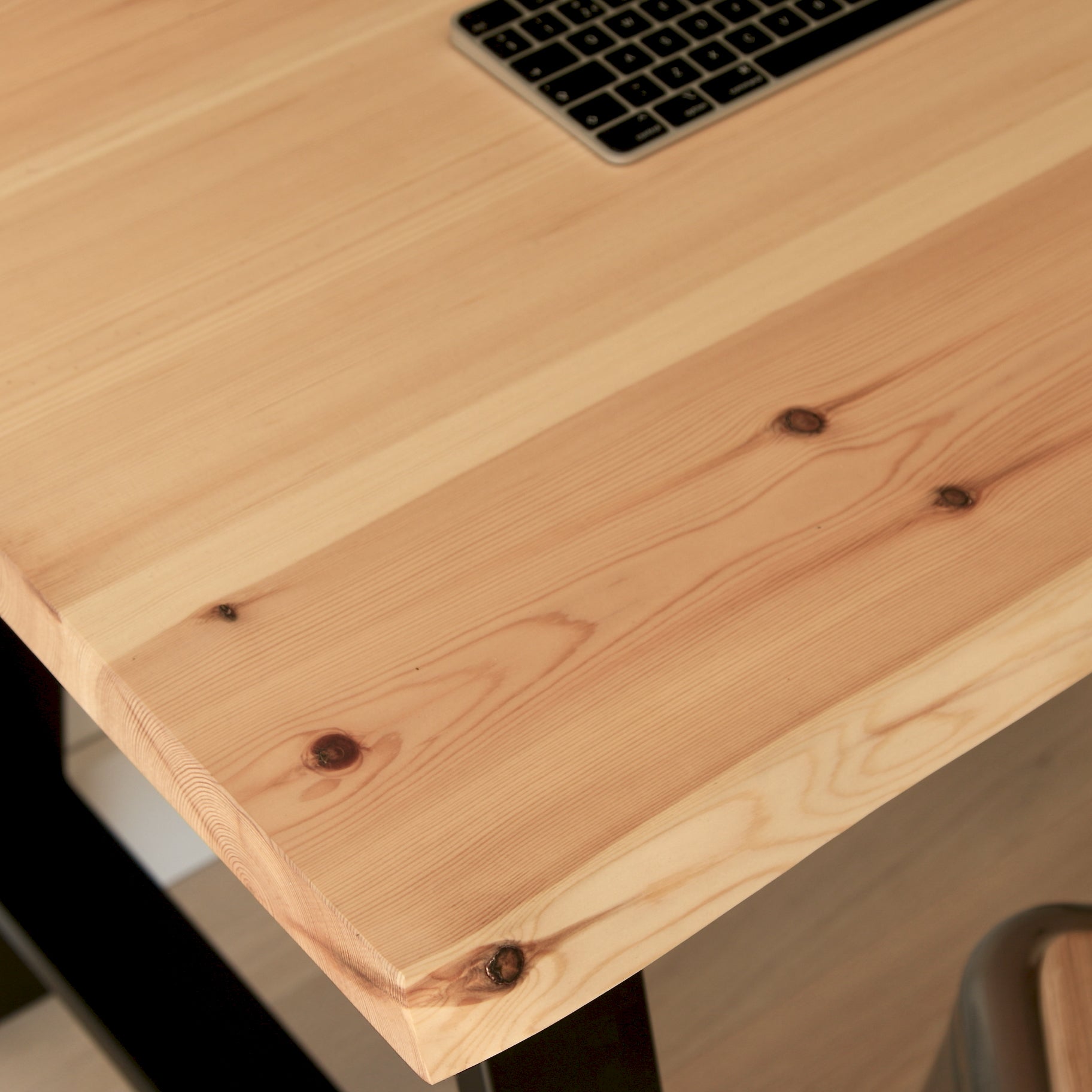 Wooden desk with a laptop on top