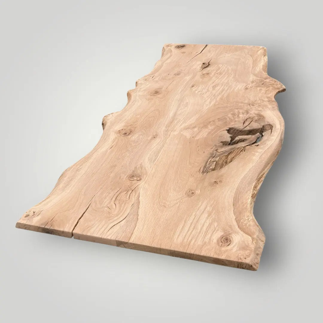 Raw wooden slab with natural grain and texture on a light gray background