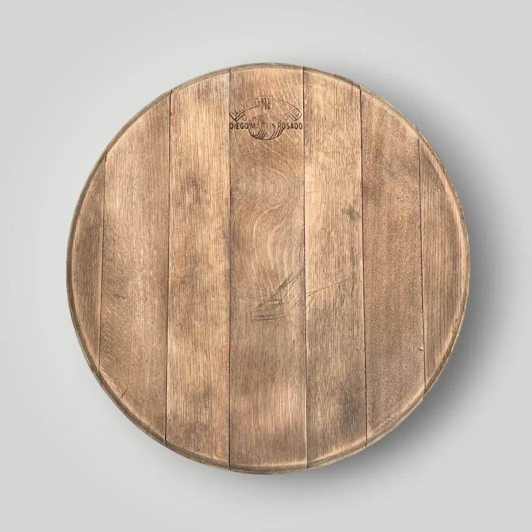 Round wooden cutting board with a visible brand logo on a gray background