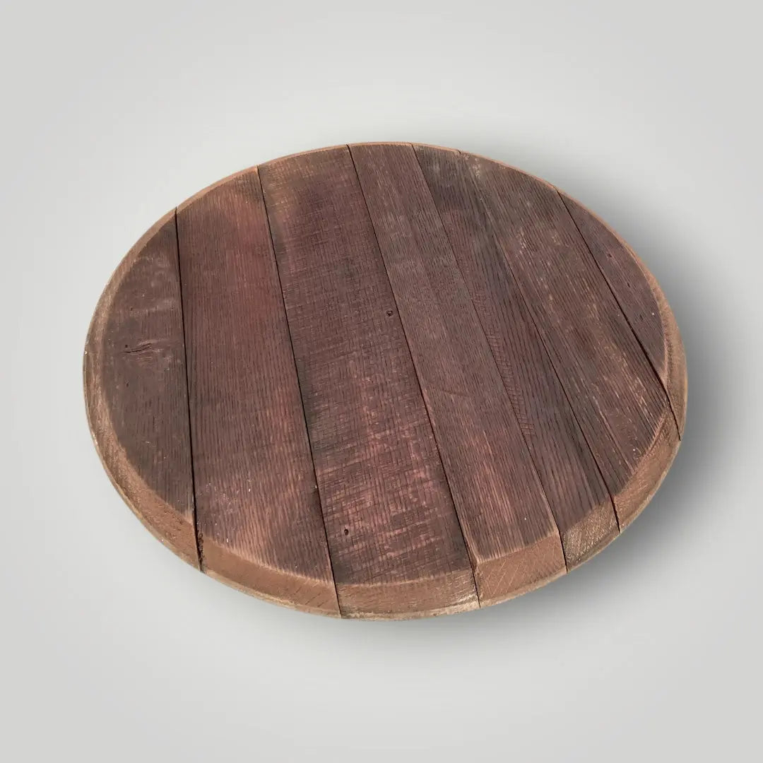 Round wooden cutting board on a light gray background