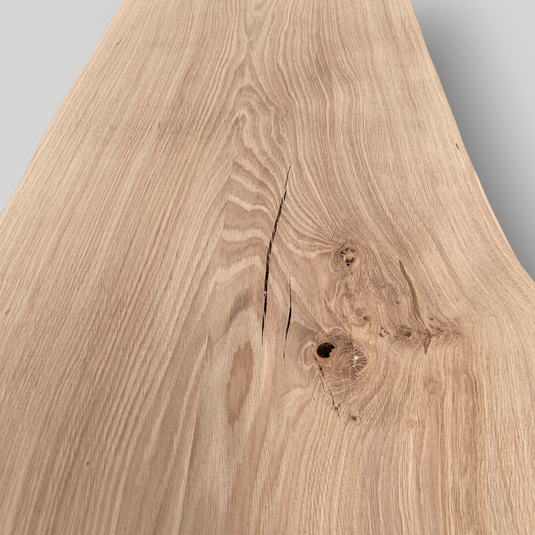Close-up of a wooden surface with natural grain and texture on a gray background