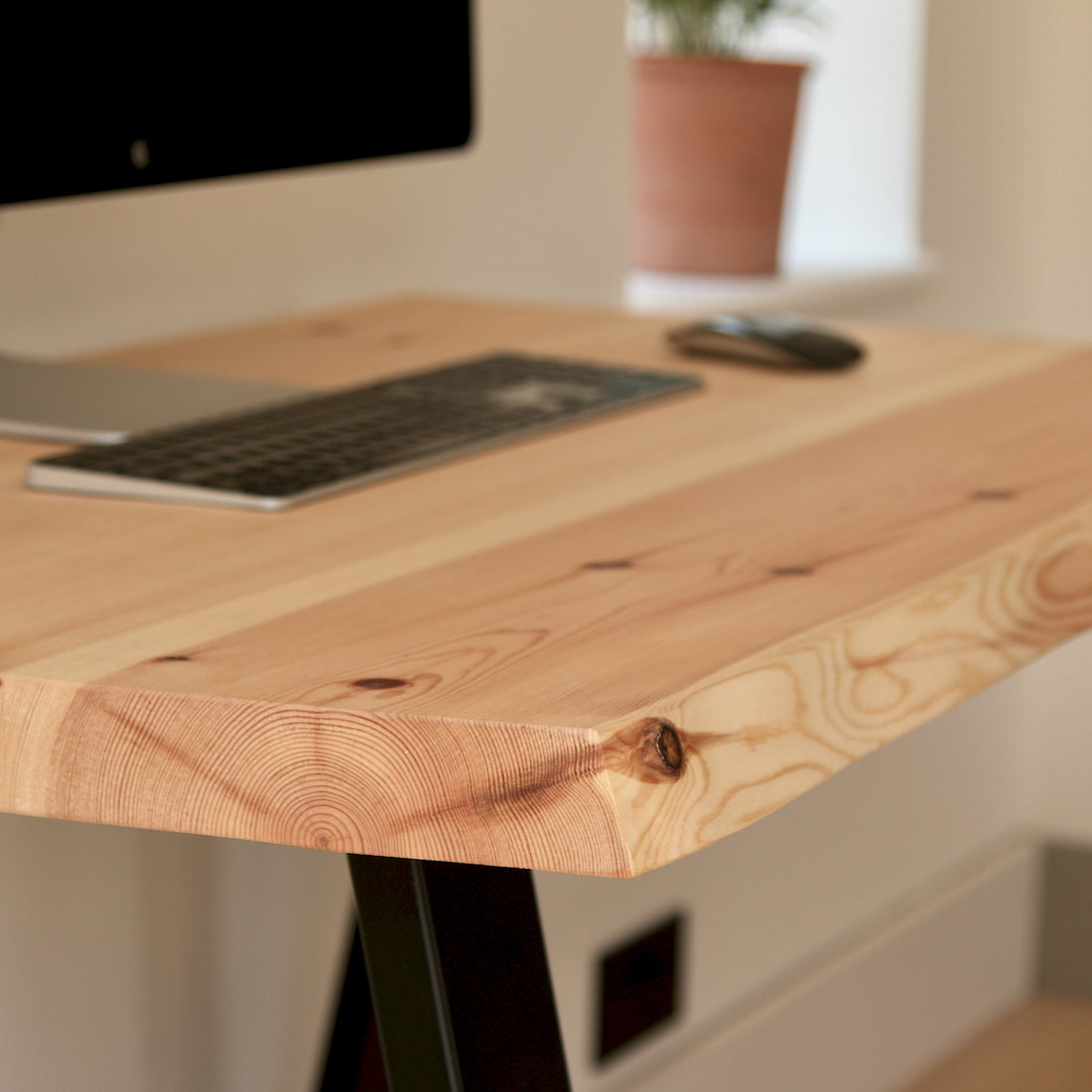 Wooden desk with computer setup in a home office setting