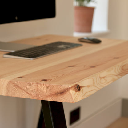 Wooden desk with computer setup in a home office setting