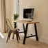 Modern home office with a wooden desk, chair, and computer monitor.