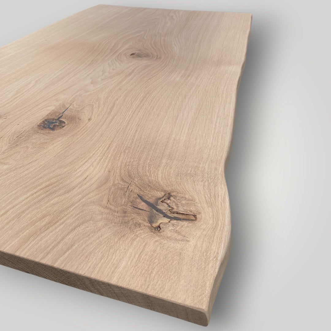 Wooden cutting board with natural grain and texture on a light gray background