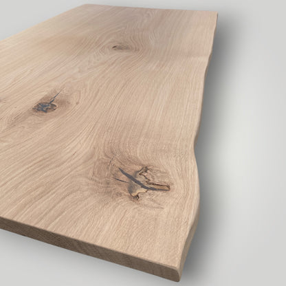 Wooden cutting board with natural grain and texture on a light gray background