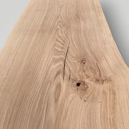 Close-up of a wooden surface with natural grain and texture on a gray background