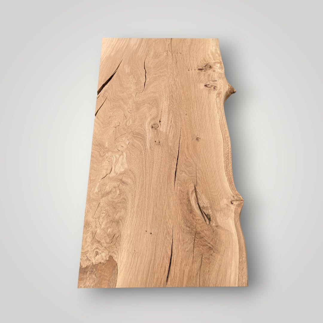 Wooden cutting board with a natural grain pattern on a gray background
