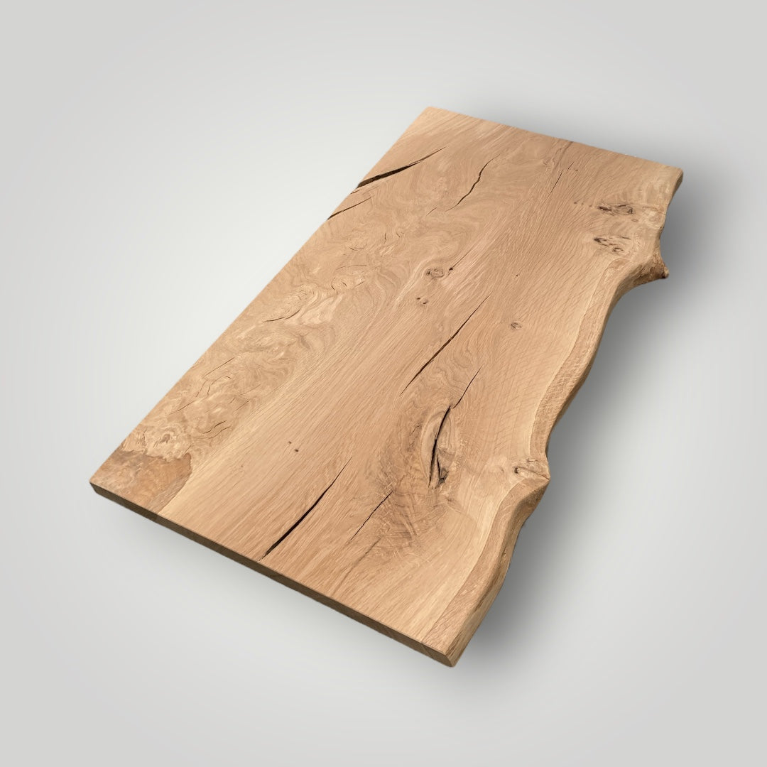 Wooden cutting board with natural edge on a light gray background