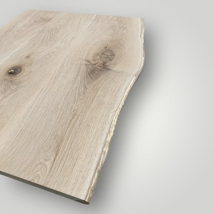 Close-up of a wooden surface with natural grain and texture on a light gray background